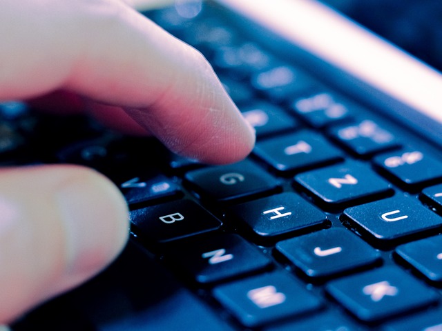 A person typing on a keyboard, focusing on insurance marketing organizations