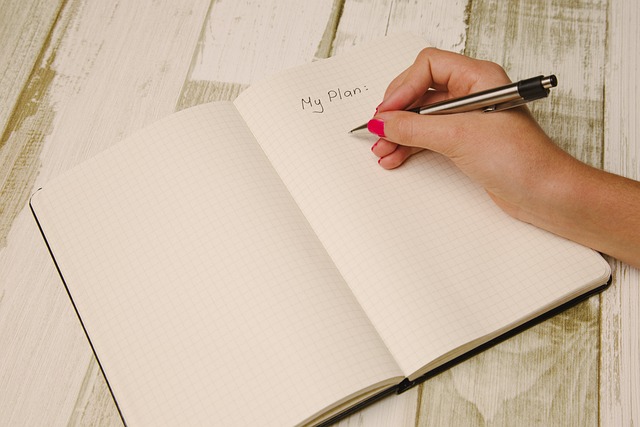 A woman writing in a notebook - capturing ideas for five effective marketing strategies that retailers can implement.