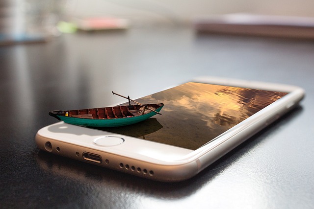 A small boat floating on a cell phone, symbolizing the benefits of online presence for businesses